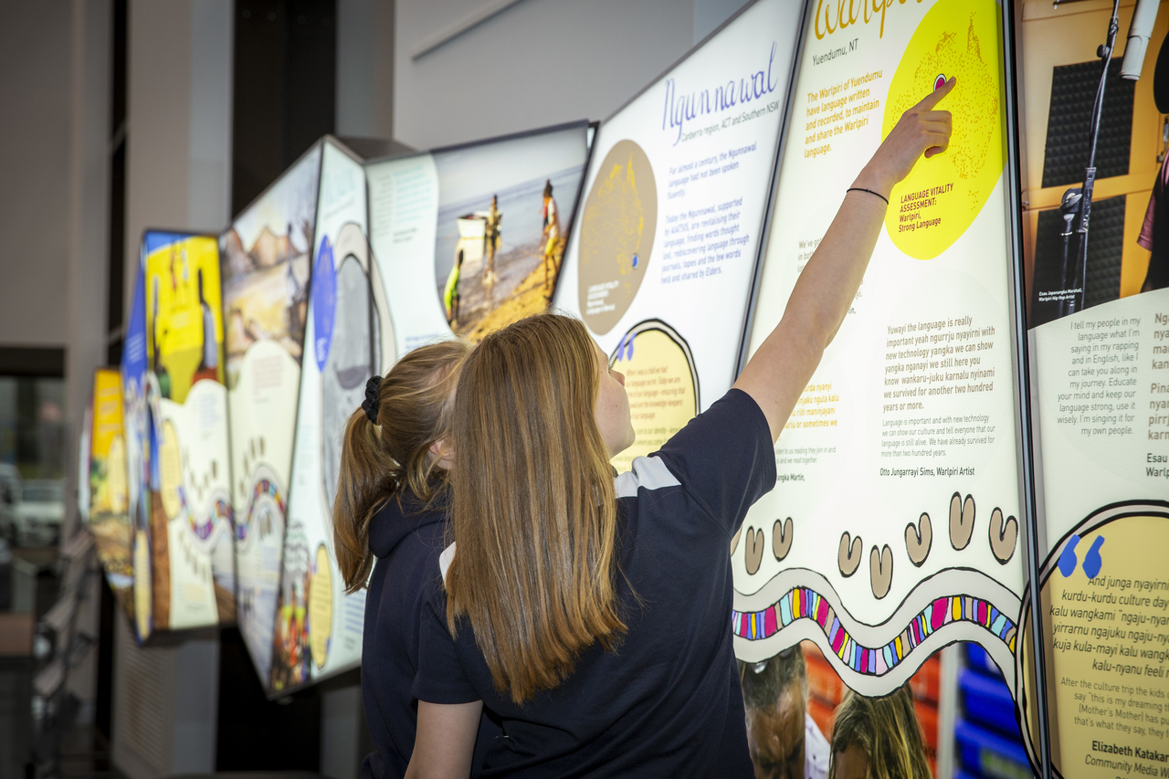 School children looking at the Our Language: Keeping Us Strong exhibition at AIATSIS