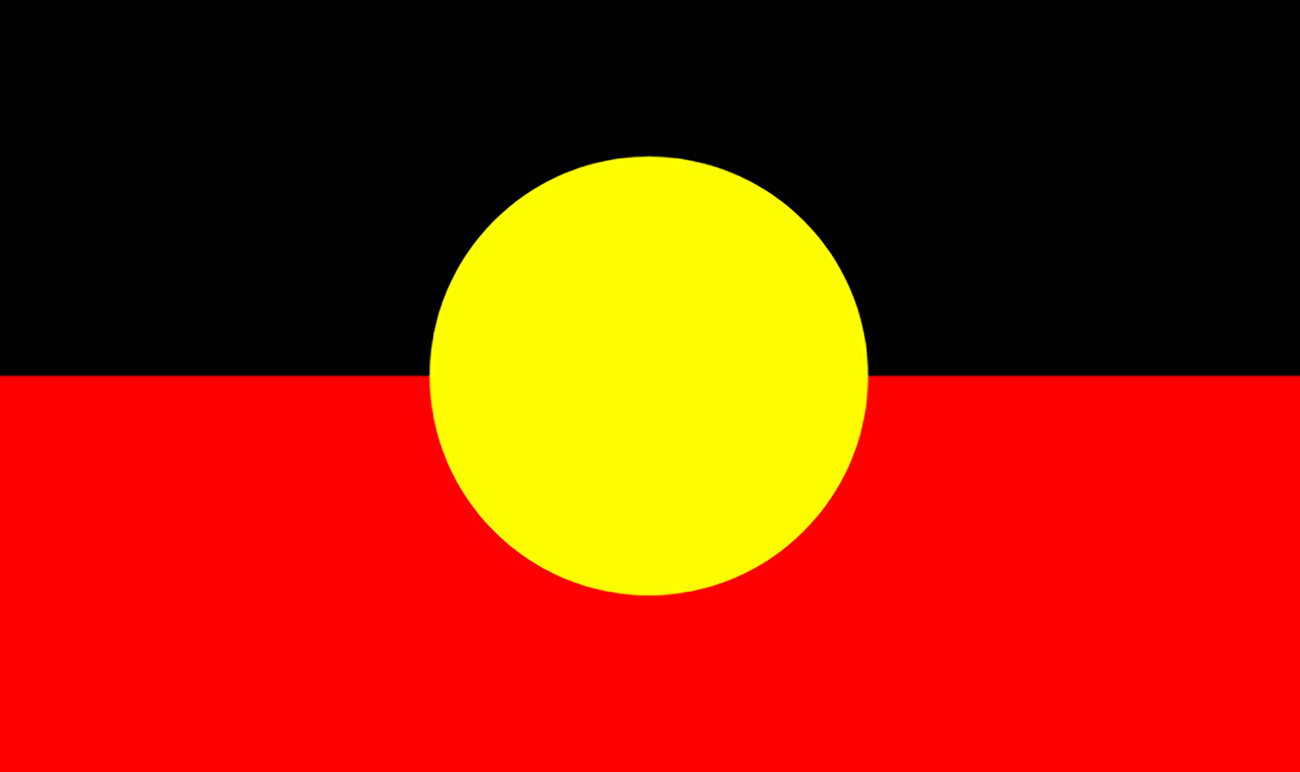 A flag with black at the top, red at the bottom and a yellow circle in the middle
