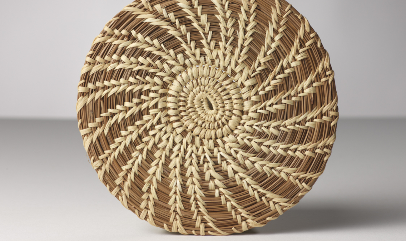 handmade pine mat circular in shape in a spiral pattern