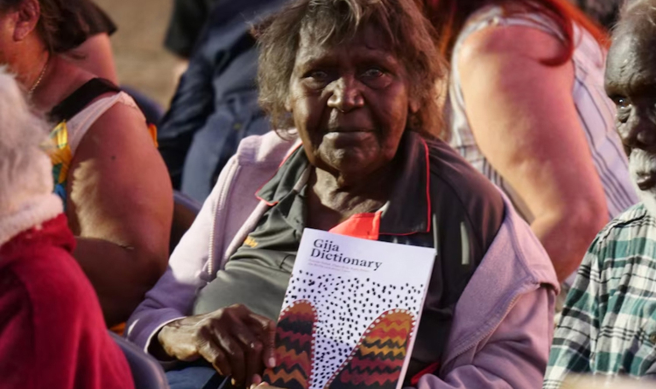 Shirley Purdie holding a copy of the Gija Dictionary