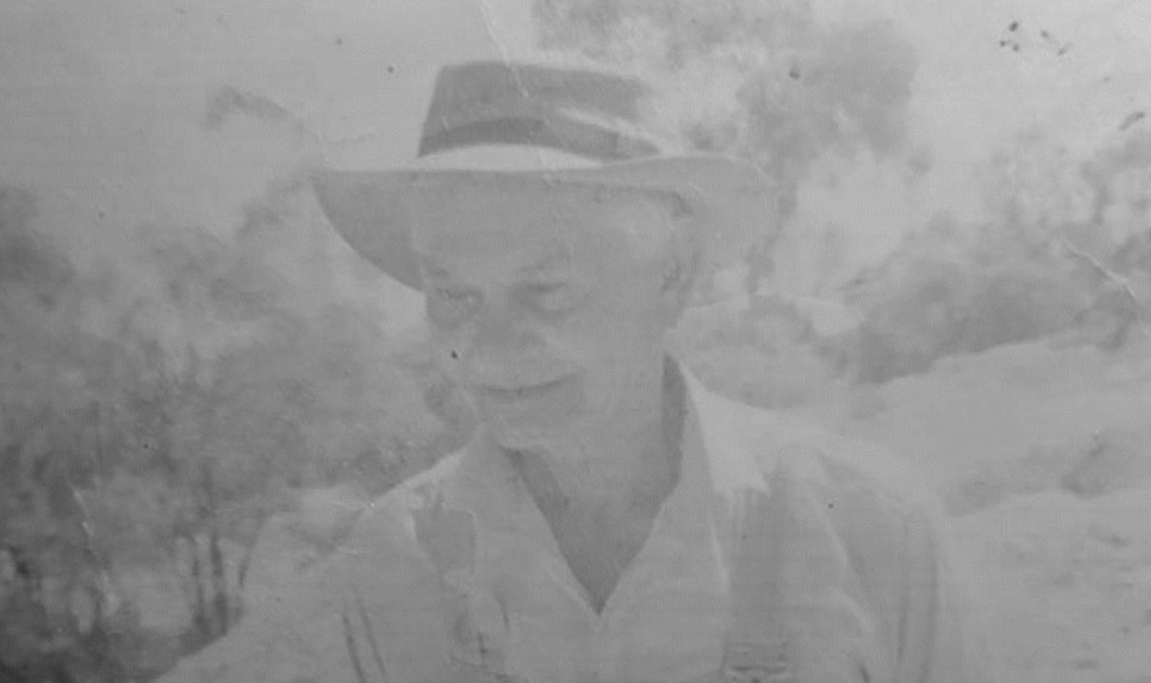 Black and white photo of an elderly Indigenous man in the bush