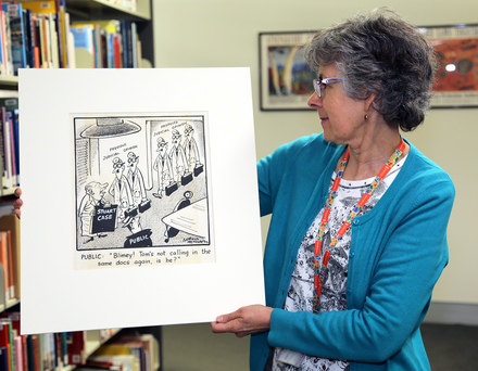 A woman holding a cartoon drawing